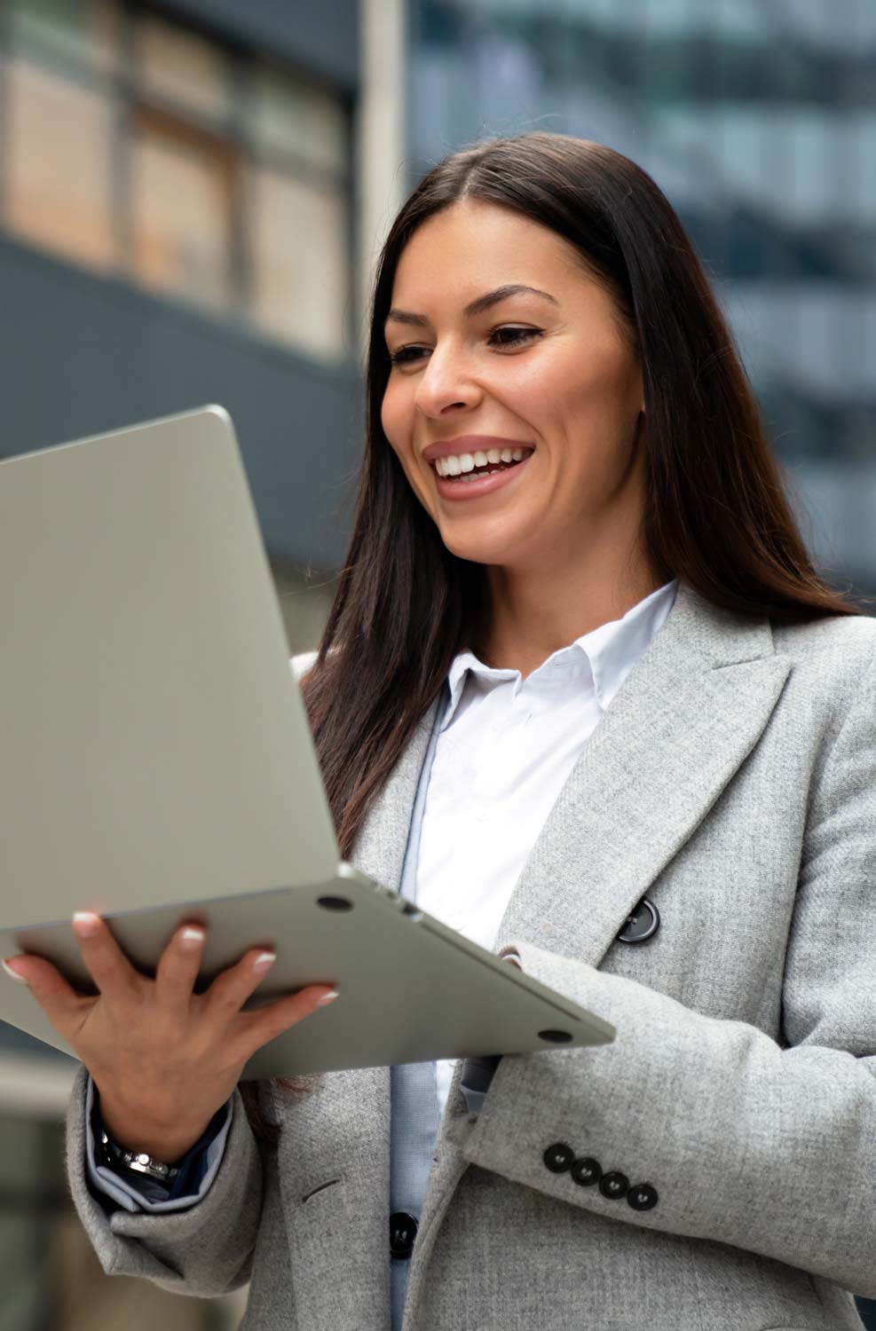 Woman in business attire on laptop